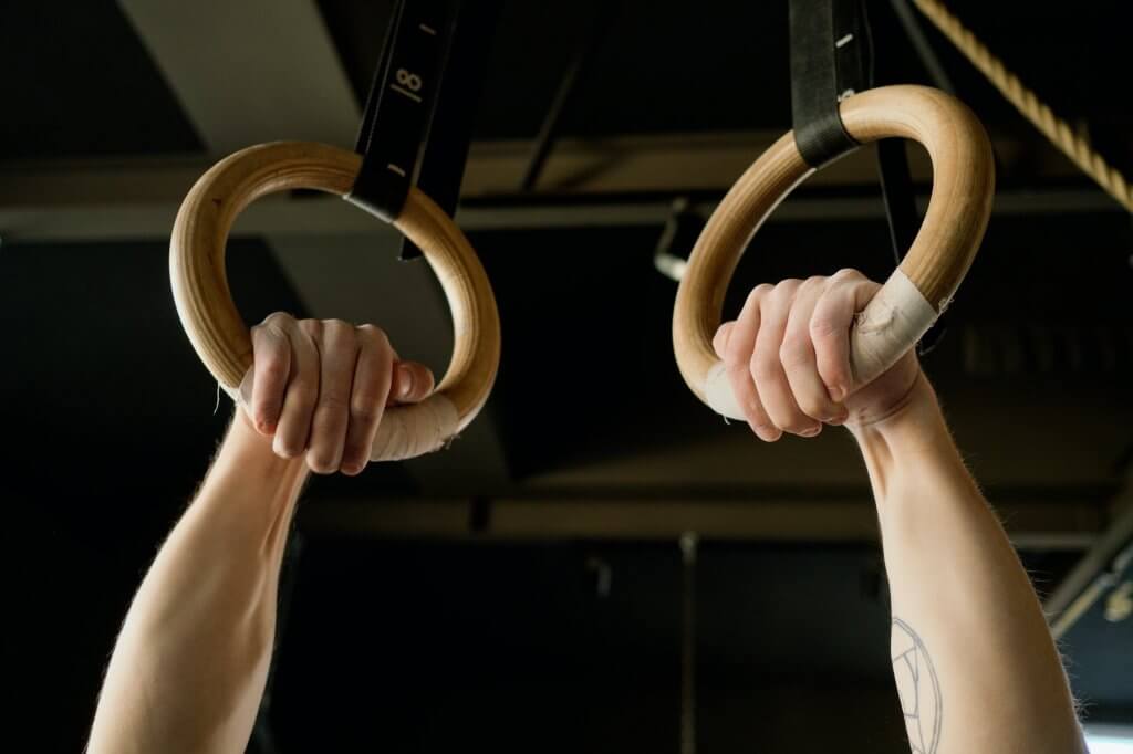 person holding gymnastic rings